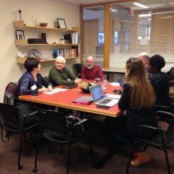 Six people (mentors and mentees) sitting around a table.